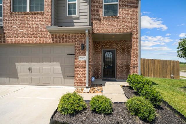 6263 El Turquesa Dr, Houston, TX 77048 - entrance to property featuring brick siding, an attached garage, fence, and concrete driveway