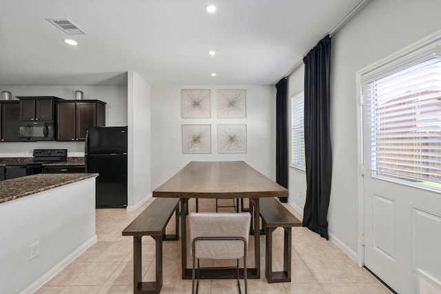 6263 El Turquesa Dr, Houston, TX 77048 - dining area featuring healthy amount of natural light, light tile patterned floors, recessed lighting, and baseboards