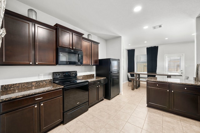6263 El Turquesa Dr, Houston, TX 77048 - kitchen with black appliances, dark stone counters, dark brown cabinets, recessed lighting, and light tile patterned floors