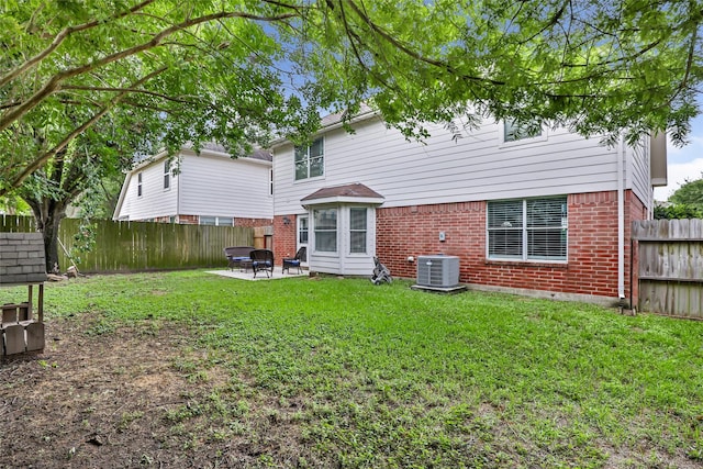 18406 Bristol Bay Ct, Humble, TX 77346 - rear view of house with brick siding, central AC unit, and a patio area