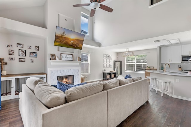 18406 Bristol Bay Ct, Humble, TX 77346 - living room featuring high vaulted ceiling, dark wood finished floors, ceiling fan, and a glass covered fireplace
