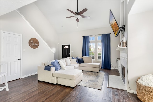 18406 Bristol Bay Ct, Humble, TX 77346 - living room featuring a ceiling fan, dark wood-type flooring, a fireplace with flush hearth, high vaulted ceiling, and baseboards