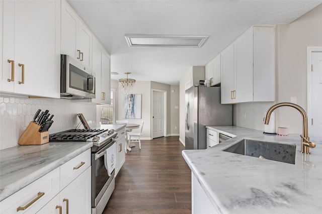18406 Bristol Bay Ct, Humble, TX 77346 - kitchen featuring stainless steel appliances, a sink, light stone countertops, dark wood-style flooring, and decorative backsplash