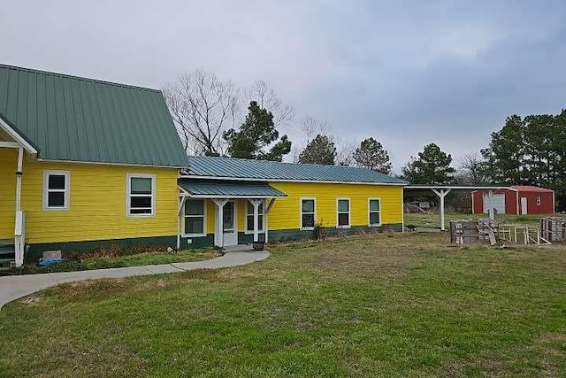 2 Birdwell Rd, Bedias, TX 77831 - rear view of property featuring a lawn and metal roof