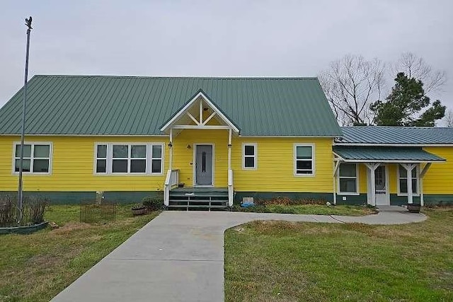 2 Birdwell Rd, Bedias, TX 77831 - view of front of property with a front lawn, metal roof, and crawl space