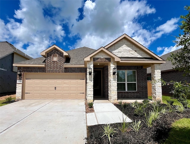 view of front of home with an attached garage, concrete driveway, roof with shingles, brick siding, and stone siding