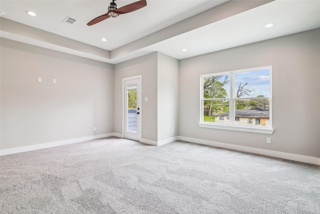 carpeted empty room featuring healthy amount of natural light, a ceiling fan, baseboards, and recessed lighting