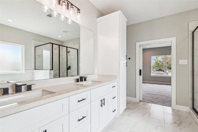 full bath with a shower stall, double vanity, marble finish floors, baseboards, and recessed lighting