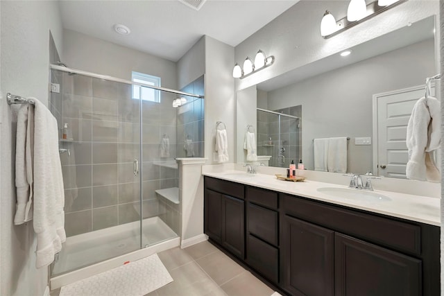 full bath featuring a stall shower, tile patterned floors, and double vanity