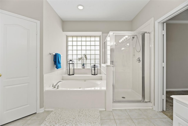 17406 Lonesome Dove Trl, Houston, TX 77095 - full bath featuring tile patterned floors, a bath, and a stall shower