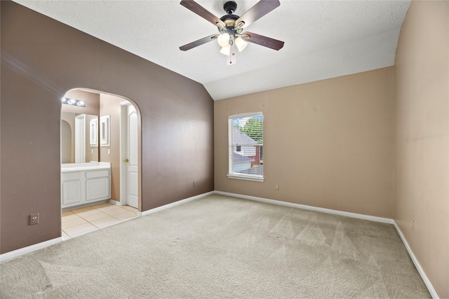 17406 Lonesome Dove Trl, Houston, TX 77095 - unfurnished room with light colored carpet, arched walkways, ceiling fan, baseboards, and lofted ceiling