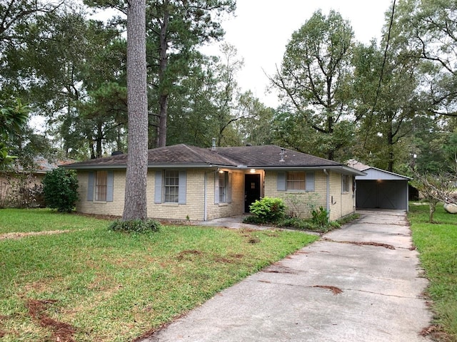 ranch-style home featuring concrete driveway, a front yard, and brick siding