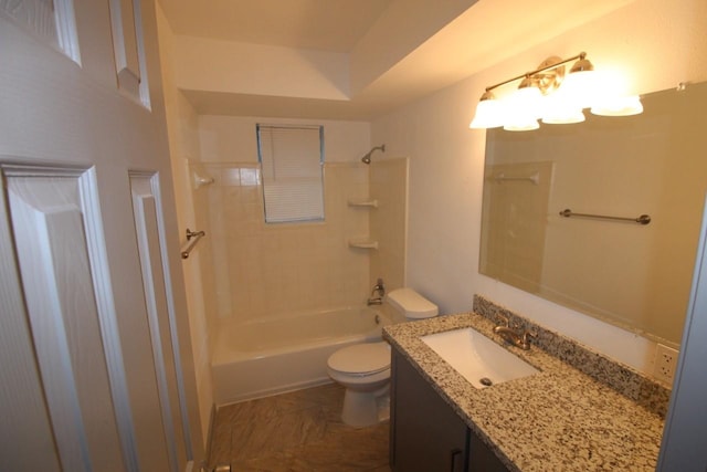 bathroom with toilet, vanity, and  shower combination
