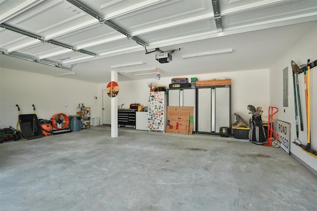 29622 Cedar Elm Way, Tomball, TX 77375 - garage featuring a garage door opener, electric panel, and freestanding refrigerator