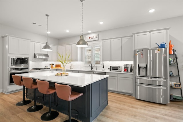 29622 Cedar Elm Way, Tomball, TX 77375 - kitchen with appliances with stainless steel finishes, under cabinet range hood, a sink, decorative backsplash, and recessed lighting