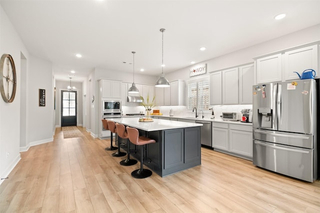 29622 Cedar Elm Way, Tomball, TX 77375 - kitchen featuring appliances with stainless steel finishes, tasteful backsplash, recessed lighting, light countertops, and a breakfast bar area