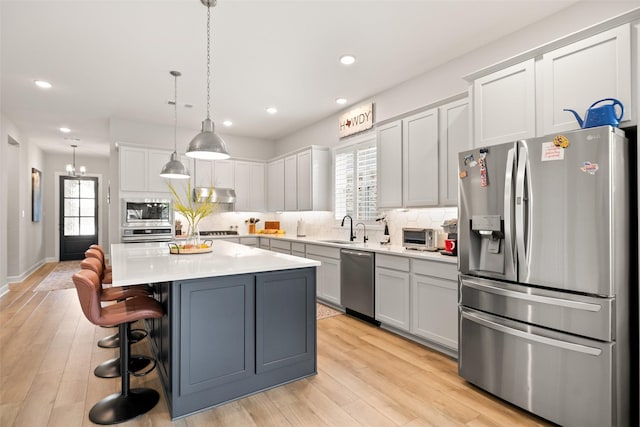 29622 Cedar Elm Way, Tomball, TX 77375 - kitchen with appliances with stainless steel finishes, a sink, under cabinet range hood, tasteful backsplash, and recessed lighting