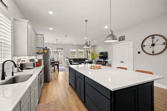 29622 Cedar Elm Way, Tomball, TX 77375 - kitchen featuring a sink, light countertops, recessed lighting, a kitchen island, and stainless steel appliances