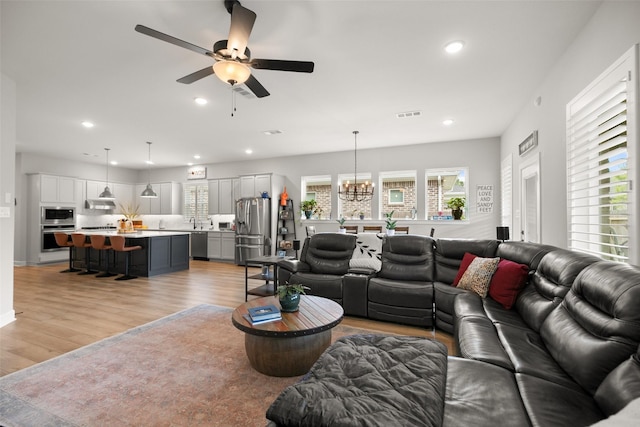 29622 Cedar Elm Way, Tomball, TX 77375 - living room featuring light wood-type flooring, a ceiling fan, recessed lighting, and a chandelier