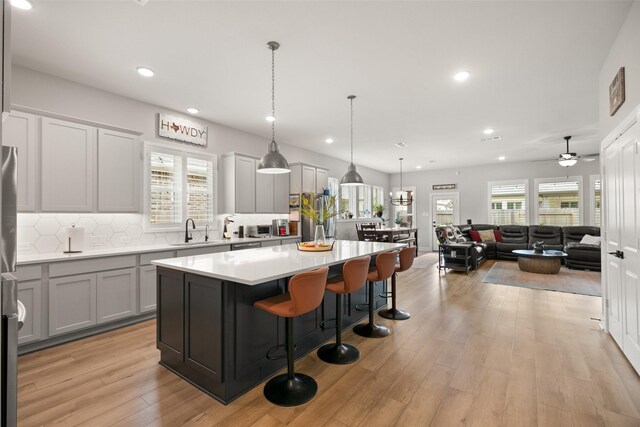 29622 Cedar Elm Way, Tomball, TX 77375 - kitchen featuring a sink, recessed lighting, a center island, tasteful backsplash, and light countertops