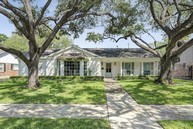 7622 Fairdale Ln, Houston, TX 77063 - view of front of house with brick siding, a front yard, and a porch