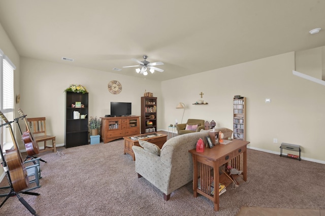 carpeted living room featuring a ceiling fan and baseboards