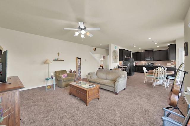 living area with ceiling fan, light colored carpet, recessed lighting, and baseboards