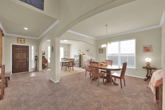 dining room featuring arched walkways, carpet flooring, ornamental molding, a chandelier, and baseboards