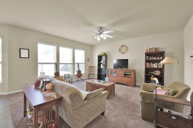 living room featuring ceiling fan and baseboards