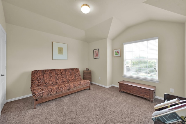 sitting room featuring carpet flooring, vaulted ceiling, and baseboards