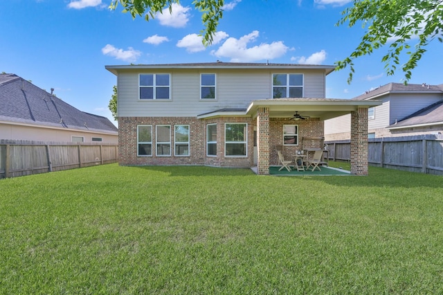 rear view of property with a ceiling fan, brick siding, and a patio area