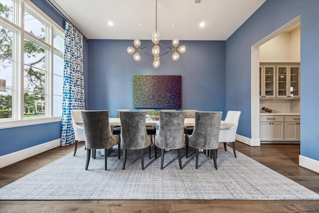 dining space featuring plenty of natural light, a chandelier, baseboards, wood finished floors, and recessed lighting