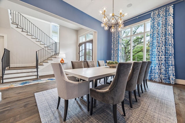 dining area with stairs, wood finished floors, a chandelier, and baseboards