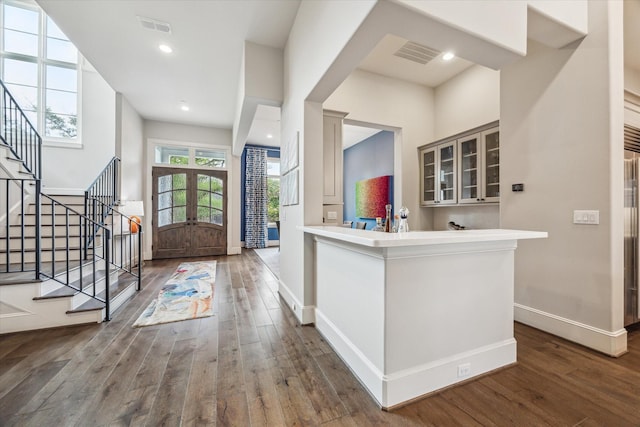foyer featuring hardwood / wood-style floors, baseboards, stairs, and recessed lighting