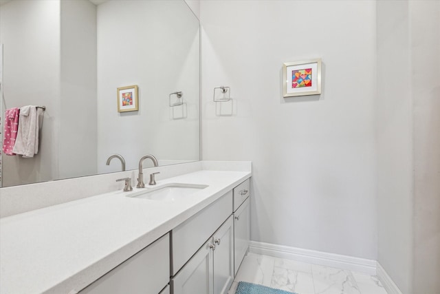 bathroom with marble look tiles, baseboards, and vanity