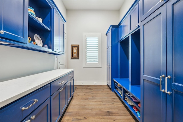mudroom with baseboards and light wood-style floors