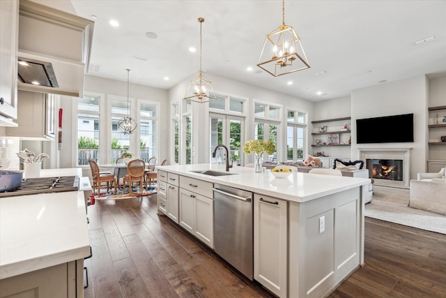 kitchen featuring a chandelier, a sink, stainless steel dishwasher, healthy amount of natural light, and recessed lighting