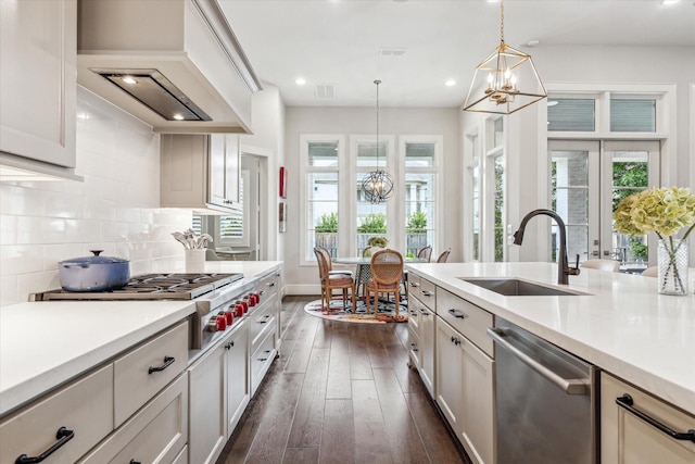 kitchen with appliances with stainless steel finishes, a sink, a chandelier, dark wood-style floors, and recessed lighting