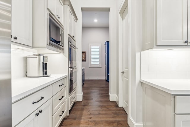 kitchen with tasteful backsplash, light countertops, dark wood-style floors, stainless steel appliances, and recessed lighting