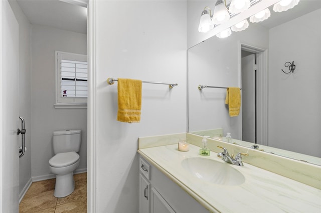 249 Hickory St, Huntsville, TX 77320 - bathroom featuring vanity, toilet, baseboards, and tile patterned flooring