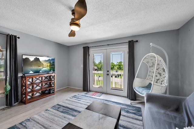 5024 County Road 476a, Freeport, TX 77541 - entryway featuring plenty of natural light, french doors, a textured ceiling, wood finished floors, and baseboards