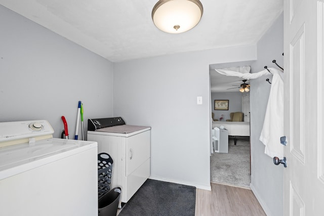 5024 County Road 476a, Freeport, TX 77541 - washroom with washer and clothes dryer, light wood-style floors, and baseboards
