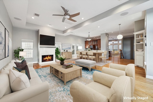 907 Rhode Pl Unit C, Houston, TX 77019 - living area featuring light wood-style flooring, a ceiling fan, a fireplace with flush hearth, recessed lighting, and baseboards