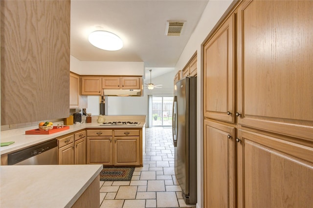 kitchen with stainless steel appliances, light countertops, under cabinet range hood, and a peninsula