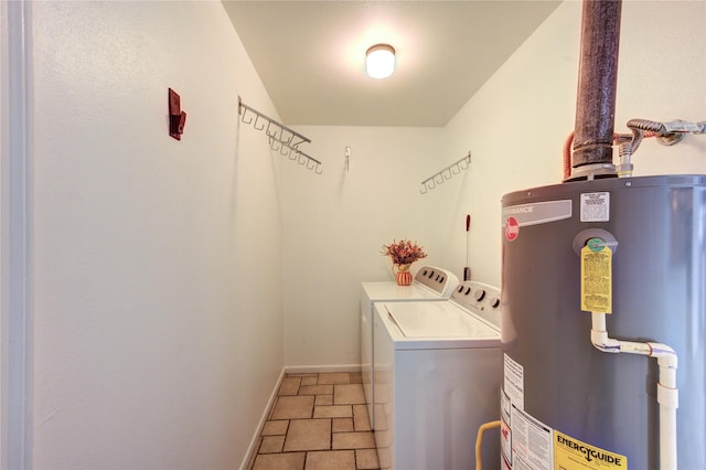 clothes washing area featuring gas water heater, independent washer and dryer, baseboards, and light stone finish flooring