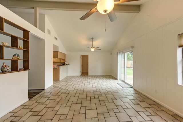 unfurnished living room with high vaulted ceiling, ceiling fan, beam ceiling, and baseboards