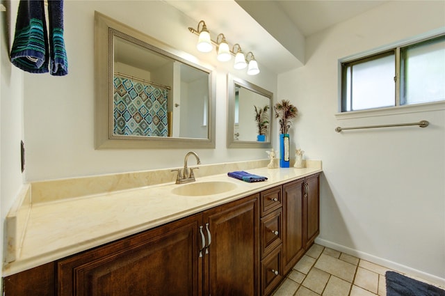 full bathroom featuring vanity, tile patterned flooring, and baseboards
