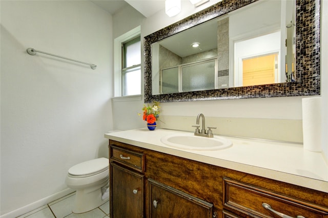 full bath featuring tile patterned floors, a shower stall, toilet, vanity, and baseboards