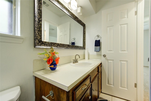 bathroom with toilet and vanity
