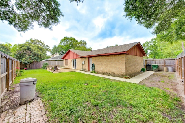 back of house with board and batten siding, brick siding, a patio area, and roof with shingles